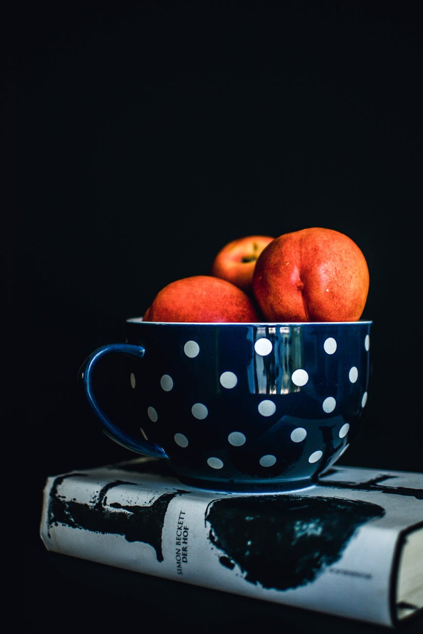 three red apples on white and black polka dot mug